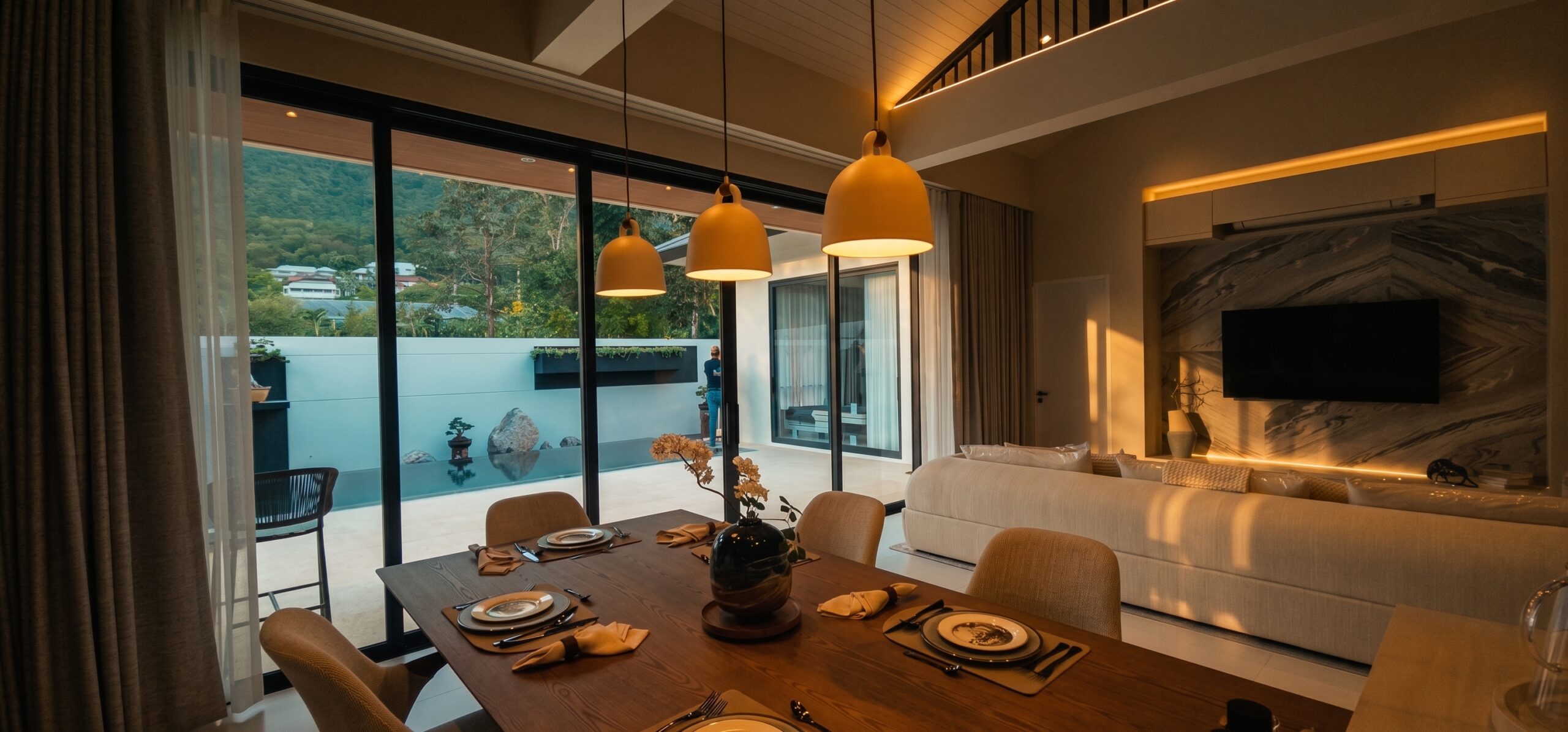 The open-plan living and dining heart opening onto the pool