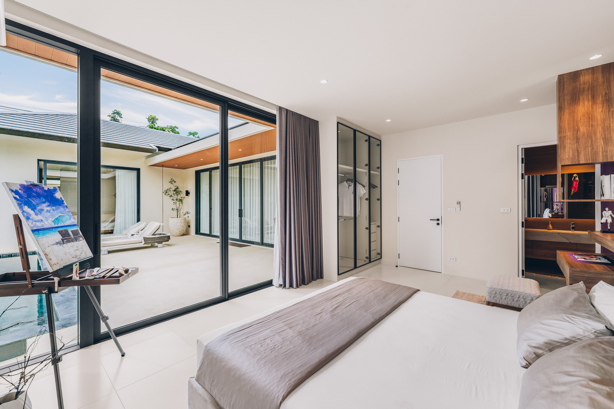 Seamless Living Space & Retractable Glass — Wide architectural view of the living pavilion, clerestory roof trusses, and pool horizon (Photo #16)